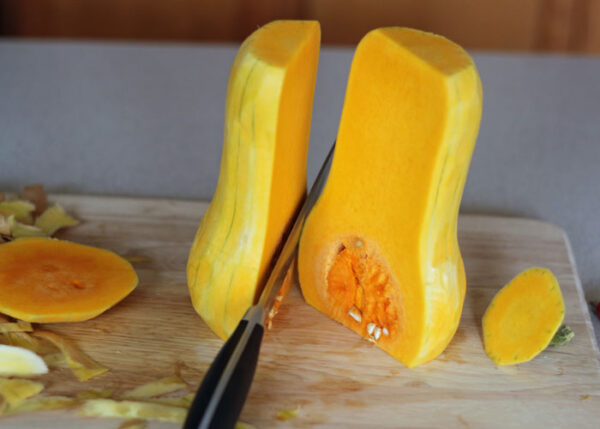 To make the roasted butternut squash recipe: Preheat your oven to 420°F (215°C). Cut squash lengthwise with a large sharp knife and scoop out seeds with a melon baller. Using a peeler, remove skin and white pith. Brush with oil and sprinkle with salt and pepper. Arrange butternut halves cut side down in a prepared baking pan side by side and roast until softened, about 20 minutes.
